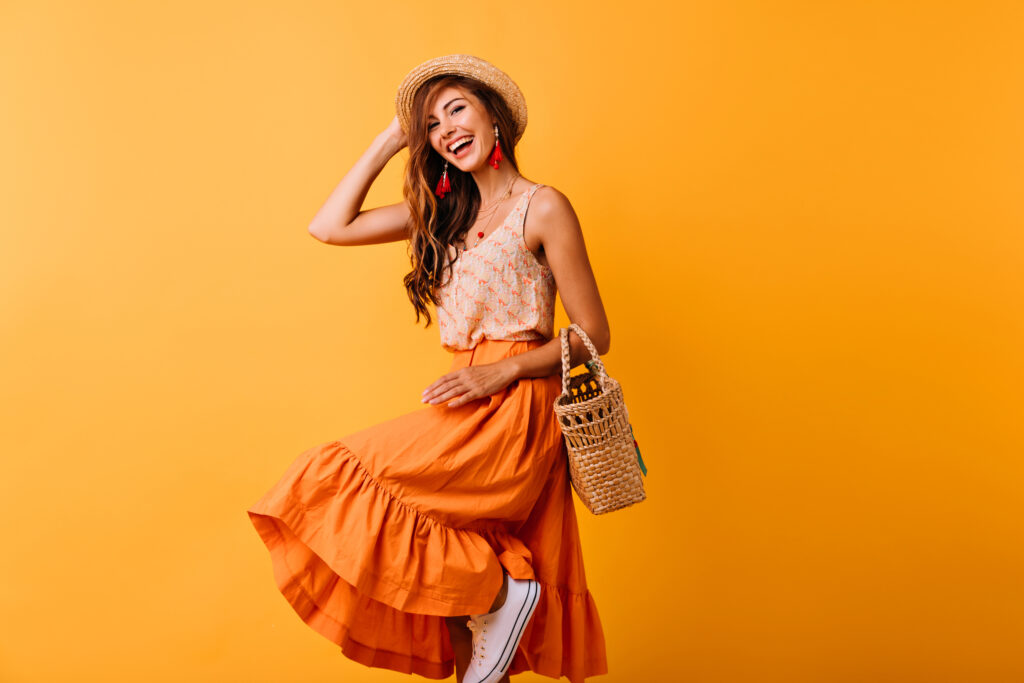 Manfaatkan Jasa Foto Produk Pakaian Profesional untuk Meningkatkan Omset Penjualan Anda joyful european lady summer hat dancing yellow background debonair girl long skirt laughing while posing studio